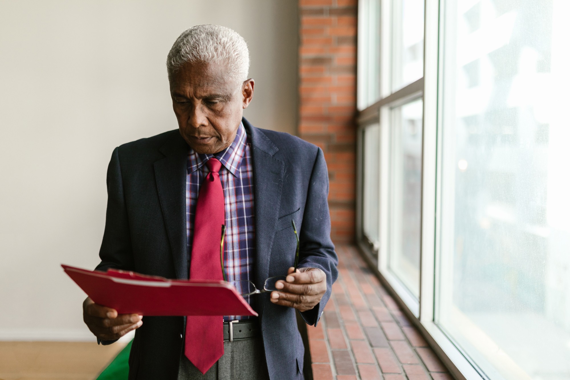 A senior professional at a window